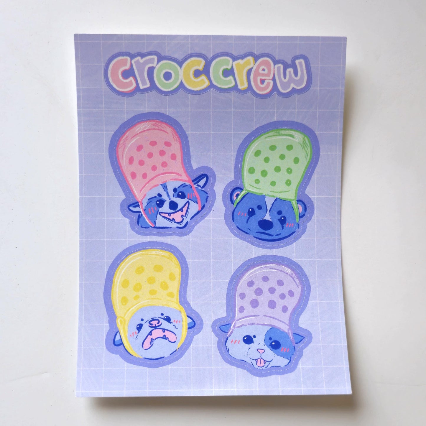Croc Crew Sticker Sheet Featuring An Opossum, Skunk, Raccoon and Cat Wearing Crocs As Hats - Koodle